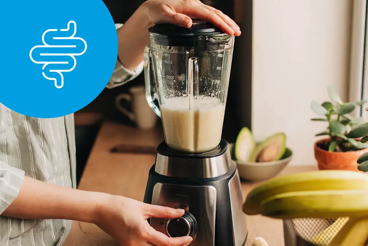 Przygotowanie smoothie, by wiedzieć, czego nie jeść przed kolonoskopią. Ikona jelit symbolizuje zdrowie układu pokarmowego.